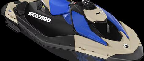 A Sea-Doo jet ski with a black and blue color scheme, a visible seat, and a control panel.