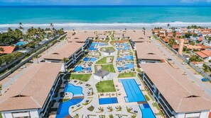 A resort with multiple swimming pools, a central courtyard, and beachfront views. - Cupe Beach Living #102d - Triple by Carpediem (Ipojuca)