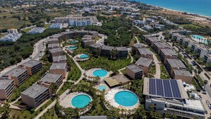 A resort with multiple swimming pools, a beach, and a view of the ocean. - Salgados Resort Beach & Nature Escape (Albufeira)