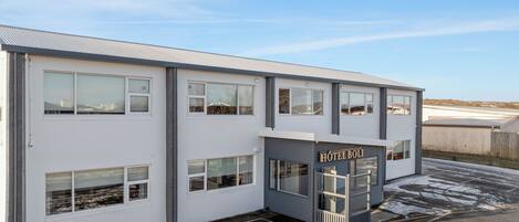 A two-story building with a sign reading "HOTEL BOLI".