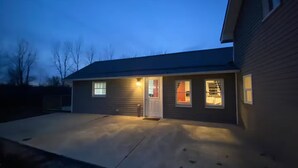 A single-story house with a front porch, a garage, and a driveway. - Buckeye Cottage (Willard)