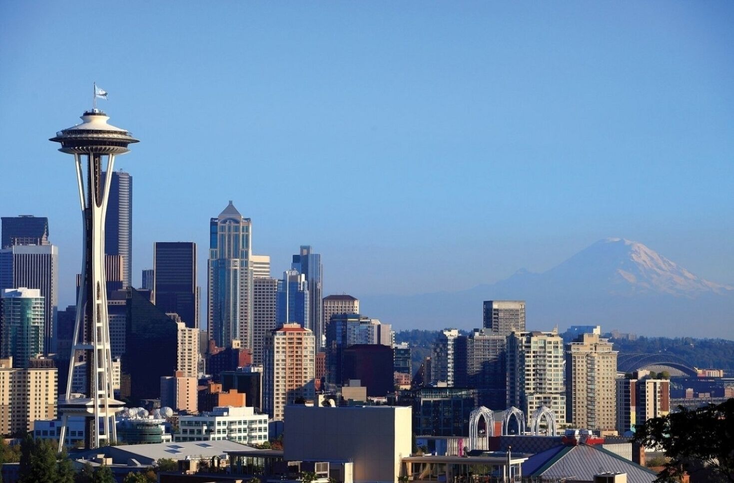 A cityscape with a prominent tower and a mountain in the background.