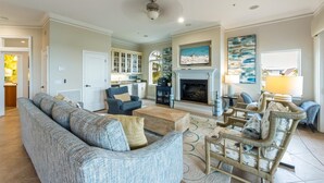 A spacious living room with a fireplace, a dining area, and a kitchen. - Direct Beach Access Beautiful Resort Balcony (Holmes Beach)