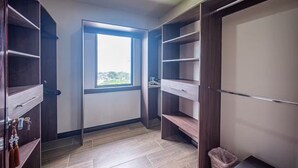 A walk-in closet with wooden shelving, a window, and a radiator. - 5 Bedroom Penthouse Ocean Views Jacobay 21002 (Jaco)