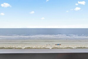 A beach with a clear sky, a sandy shore, and a few people. - "The Salty Compass" 3 BR Ocean Front in Windy Hill (North Myrtle Beach)