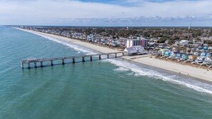 A coastal town with a pier extending into the ocean, beachfront houses, and a distant mountain range. - Anchors Away Two Blocks to Surfside Beach. (Surfside Beach)