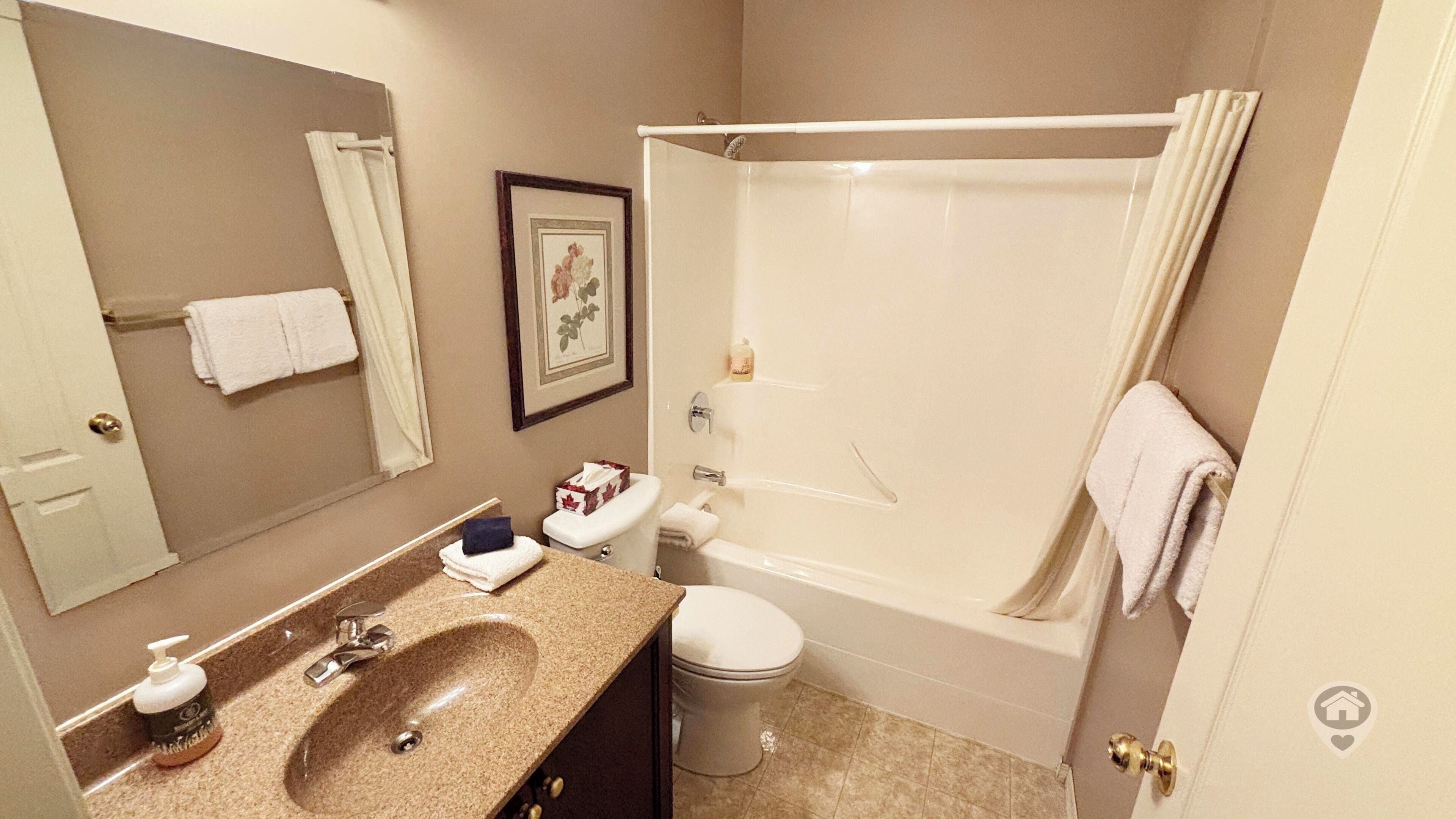 A bathroom with a sink, toilet, and bathtub.