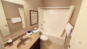 A bathroom with a sink, toilet, and bathtub.