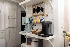 A coffee station with a coffee maker, a basket, and a coffee grinder. - Wellness Lodge - Sauna, cold plunge, jacuzzi (Morganton)