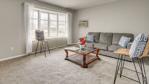 A living room with a grey sofa, two chairs, a coffee table, and a window with blinds. - 6 Mi to Downtown Columbus: Quiet Home w/ Yard (Columbus)