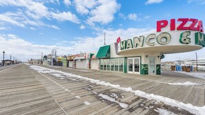 A boardwalk with a pizza restaurant named "Manco & Co." - Walk to Shore! Family Haven w/ Pool in Ocean City (Ocean City)