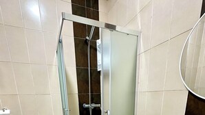 A bathroom with a glass-enclosed shower, a white sink, and a toilet. - Apartment 4 min Tgv and Beach (Tanger)