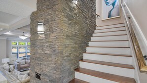 A staircase with wooden steps and a stone wall. - All-in-one Luxury Escape Three Properties, Event Hosting, Private Pond & Full Gym (Jacksonville)