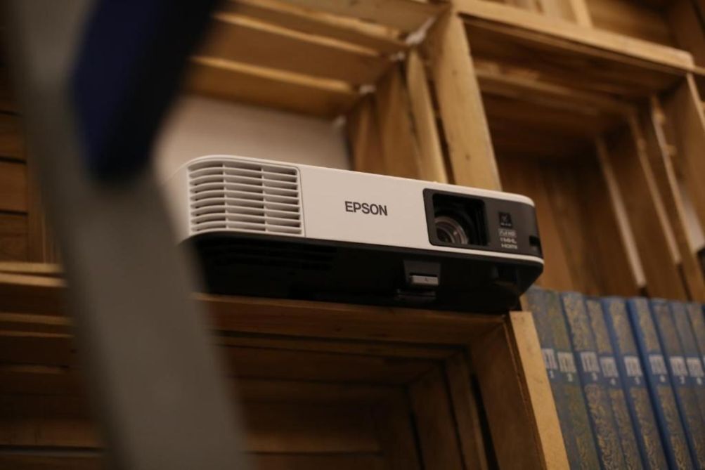 An Epson projector mounted on a wooden structure.