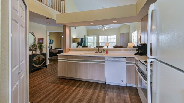 A spacious kitchen with a central island, a dishwasher, a refrigerator, and a ceiling fan. - Perfect 3 Bedroom-3 Bath Condo / Gorgeous Views / Heart of Branson/ Affordable (Branson)