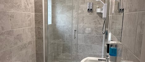 Shower, hair dryer, towels, toilet paper