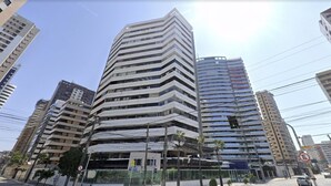 A modern multi-story building with a unique angular design, featuring balconies and large windows. - Aquidaba #803 - Apto With sea View by Carpediem (Fortaleza)