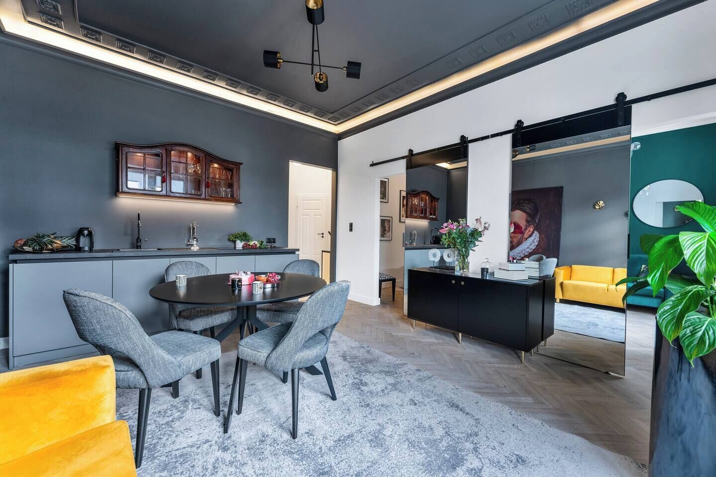 A modern interior with a dining area, kitchen, and living space.