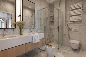 A modern bathroom with a glass-enclosed shower, a large mirror, a white sink, and a toilet. - Sandstone 2-Bed Apartment in the Heart of Kraków (Kraków)