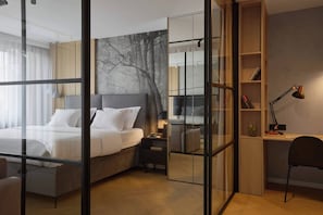 A modern hotel room with a large bed, a desk, a chair, and a bookshelf. - Vistula View Roof terrace 1-bed Apartment (Kraków)
