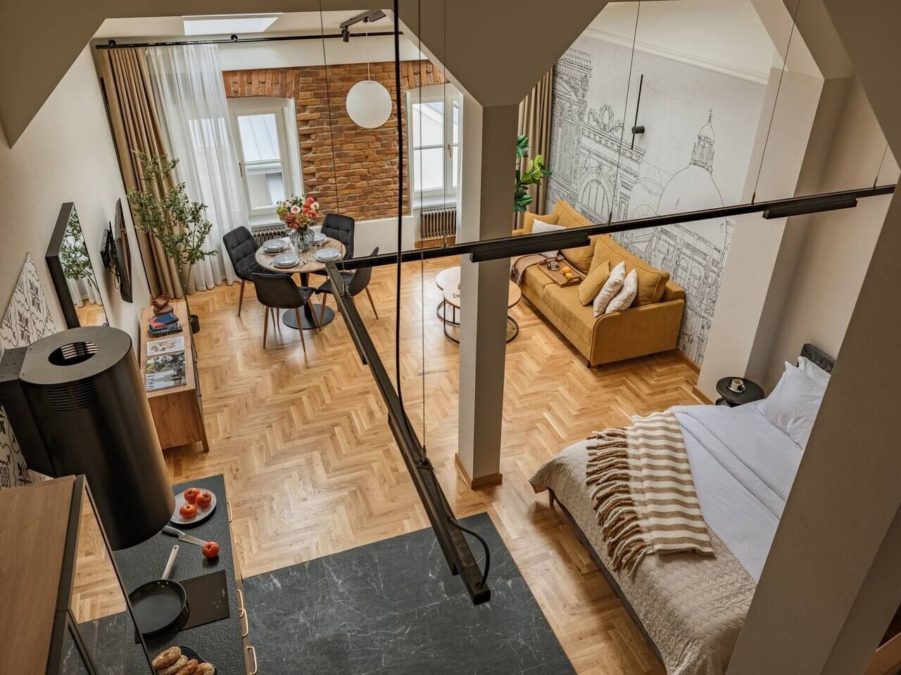 A loft-style apartment with a dining area, kitchen, and a bedroom.