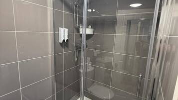 Shower, hair dryer, towels, toilet paper