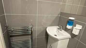 Shower, hair dryer, towels, toilet paper