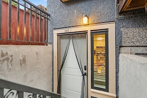 A building with a sign reading 'SUITE 2' above a door with a window.