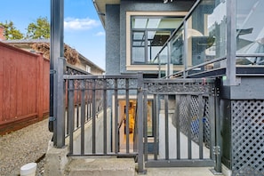A gated entrance to a building with a staircase leading to an upper level.