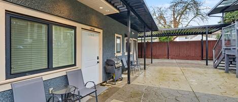A covered patio area with outdoor seating, a barbecue grill, and a garage door labeled 'LANNYWAY.'