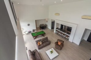 A spacious living area with a pool table, sofas, and a bar area. - 7 Bedroom Penthouse Ocean & Mountain Views JB41001 (Jaco)