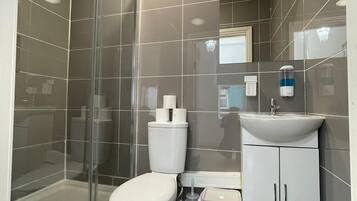 Shower, hair dryer, towels, toilet paper