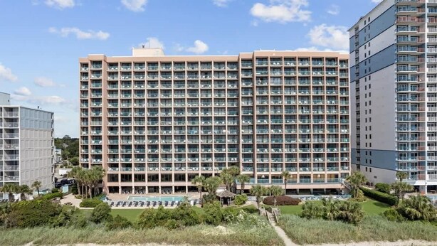 A large hotel with multiple floors, a swimming pool, and a beach area. - New Direct Ocean View 12th Floor, Sandcastle South (Myrtle Beach)