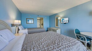 A hotel room with a large bed, a desk, a chair, and a TV mounted on the wall. - New Direct Ocean View 12th Floor, Sandcastle South (Myrtle Beach)