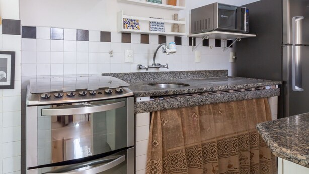 A kitchen with a stove, oven, microwave, and refrigerator. - Charm in Copacabana Stc1002 (Rio de Janeiro)