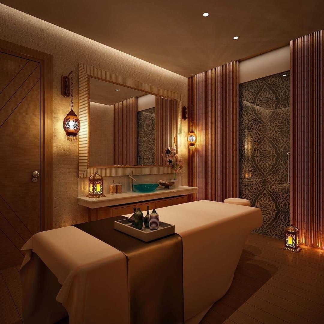 A modern spa room with a large mirror, wooden paneling, and ambient lighting.