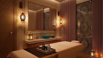 A modern spa room with a large mirror, wooden paneling, and ambient lighting.