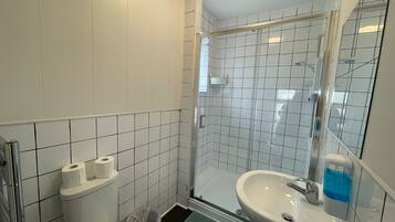 Shower, hair dryer, towels, toilet paper