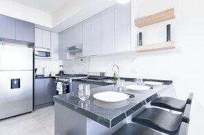 Junior Suite, Balcony, City View | Private kitchen | Fridge, microwave, stovetop, blender