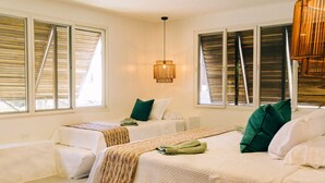 A hotel room with two beds, a large window with blinds, a hanging light fixture, and a view of the outside. - La Perla @ Rocamar (Jicalapa)