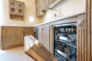 Eine Küche mit Holzausstattung, einem Geschirrspüler und einem eingebauten Backofen.