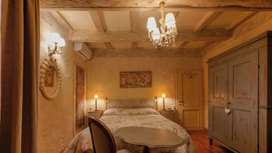 A bedroom with a bed, a chair, a table, and a wardrobe. - Gallery Guesthouse (Bologna)