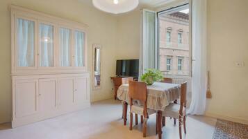 Apartment (Bilocale - Via de Castagnoli 14) | Living area | 43-inch flat-screen TV with cable channels