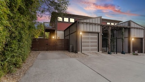A modern two-story house with a garage and a covered driveway.