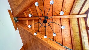 A wooden ceiling with a central black fixture and multiple white lights. - Rider Apartment - 8 Guests, 4 Bedrooms (Pal)