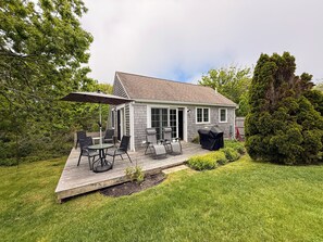 A house with a deck, outdoor furniture, and a grill. - Nauset Heights Carriage House (Orleans)