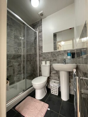 Shower, hair dryer, towels, toilet paper