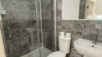 Shower, hair dryer, towels, toilet paper