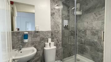 Shower, hair dryer, towels, toilet paper