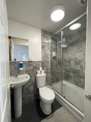 Shower, hair dryer, towels, toilet paper